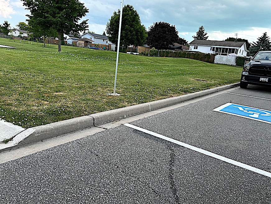 accessible parking space that exits onto grass or curb area next to Briar Ridge Park in Amherstburg, Ontario